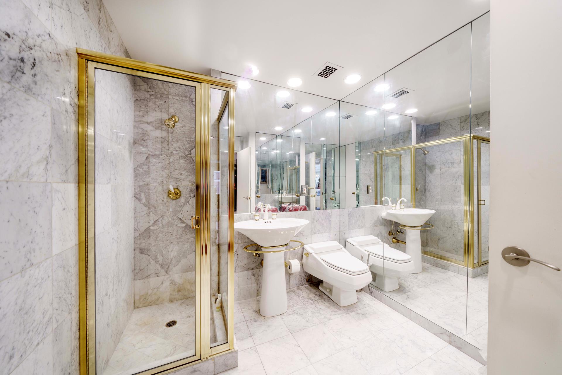 475 Park Avenue, Unit 11BC Manhattan, NY 10022 - Photo 11 of 15 a bathroom with a toilet a sink and shower