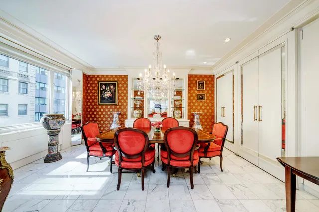 a living room with furniture white walls and a chandelier