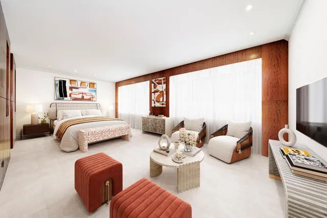 a bedroom with furniture and a flat screen tv