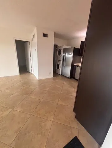 a view of a livingroom with an empty space and a fireplace