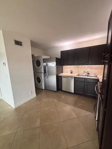 a kitchen with stainless steel appliances a stove a sink and a refrigerator