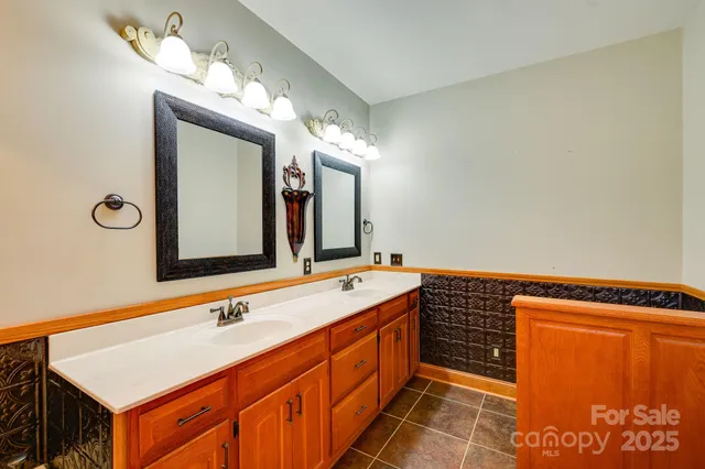 a spacious bathroom with a double vanity sink and a mirror