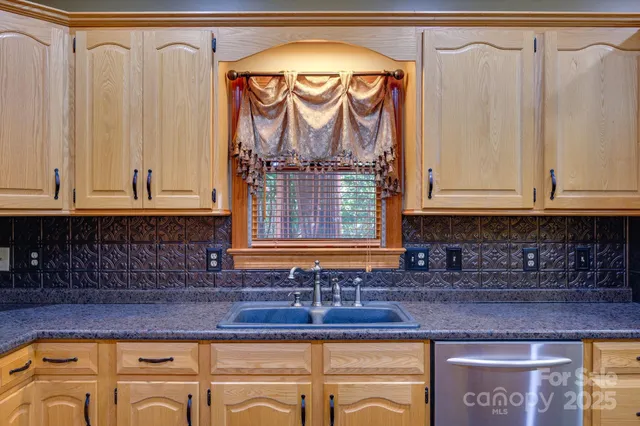 a kitchen with granite countertop a sink and a stove