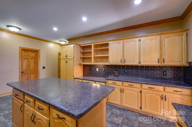 a kitchen with a sink a counter top space and stainless steel appliances