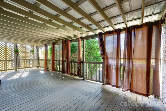 a front view of a house with a yard covered with snow
