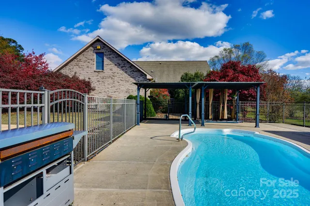 a view of a house with swimming pool and sitting area