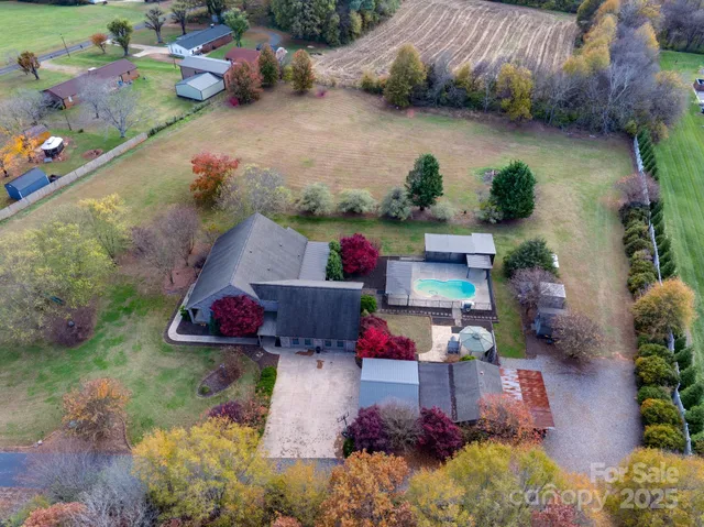 an aerial view of a house with a yard and lake view