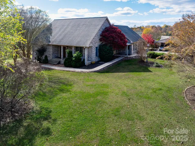 a view of a house with a yard and sitting area