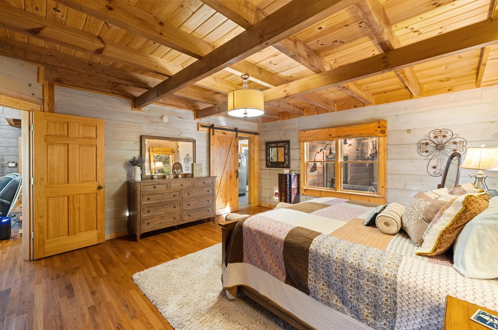 60 Ford Road Dahlonega, GA 30533 - Photo 16 of 59 a bedroom with a bed and wooden floor