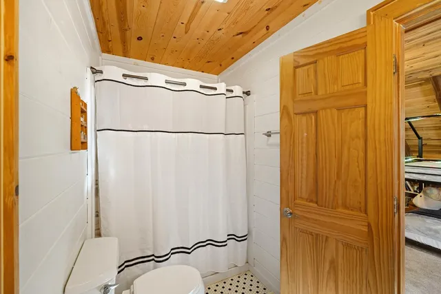 a bathroom with a toilet and a shower