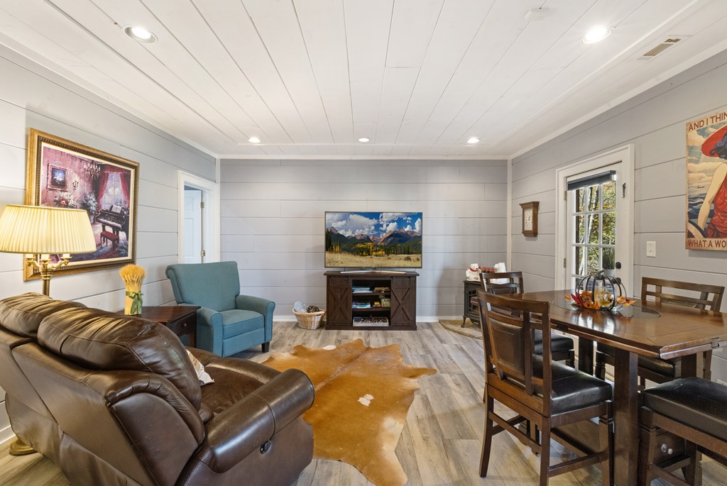 60 Ford Road Dahlonega, GA 30533 - Photo 35 of 59 a living room with furniture a fireplace and a flat screen tv