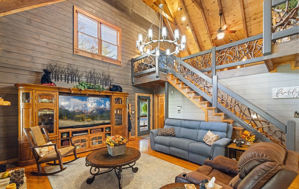 60 Ford Road Dahlonega, GA 30533 - Photo 8 of 59 a living room with furniture a flat screen tv and a floor to ceiling window