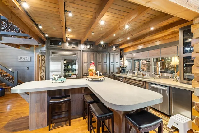 a dining room with a wooden table and chairs