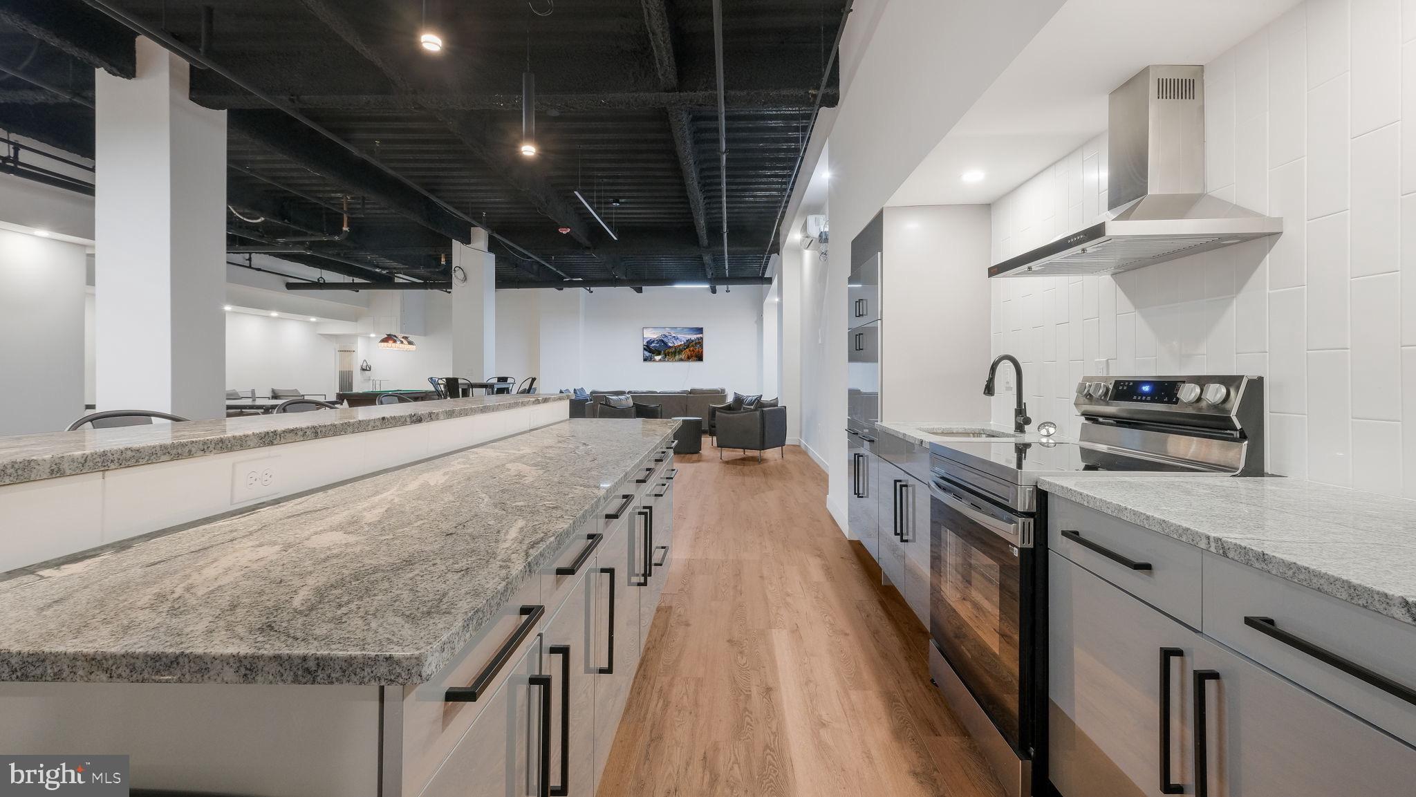 1825 Callowhill Street, Unit 504 Philadelphia, PA 19130 - Photo 49 of 49 a kitchen with stainless steel appliances granite countertop sink stove and refrigerator