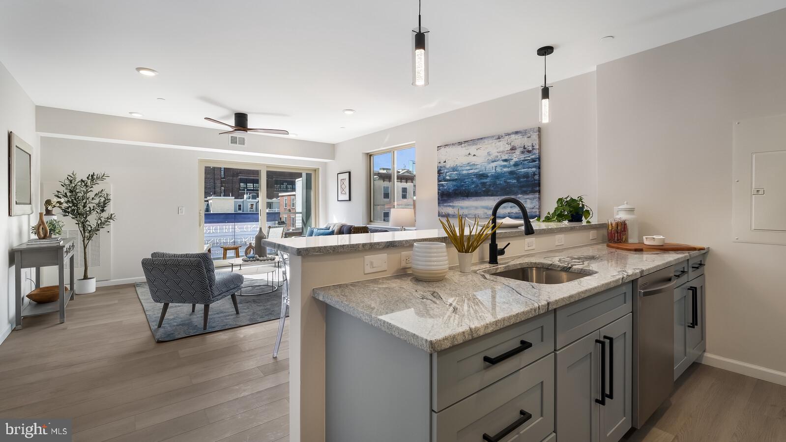 1825 Callowhill Street, Unit 504 Philadelphia, PA 19130 - Photo 5 of 49 a view of living room with kitchen island furniture and wooden floor
