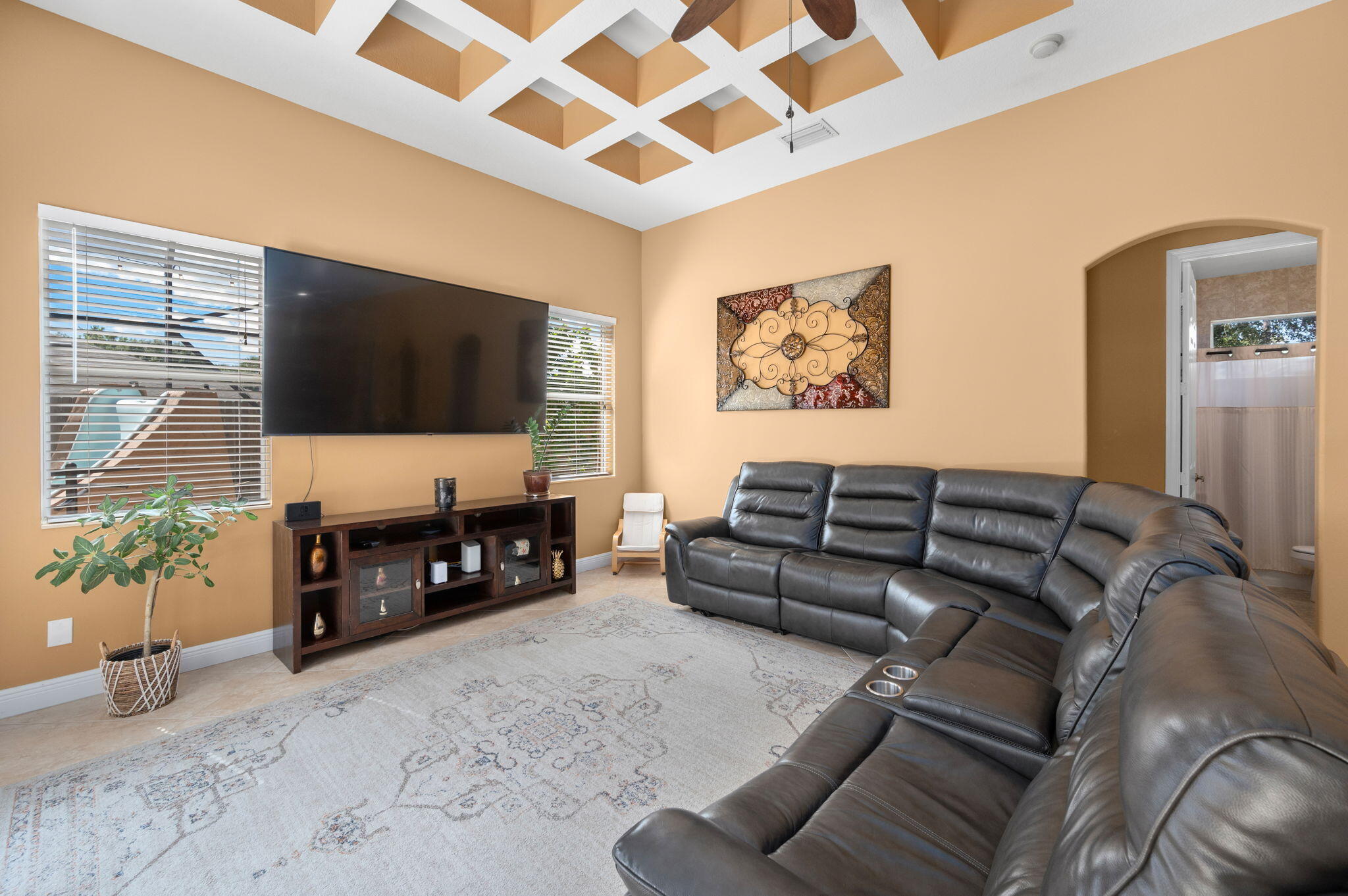 1438 Southwest Apache Avenue Port St. Lucie, FL 34953 - Photo 13 of 34 a living room with furniture a flat screen tv and a fireplace