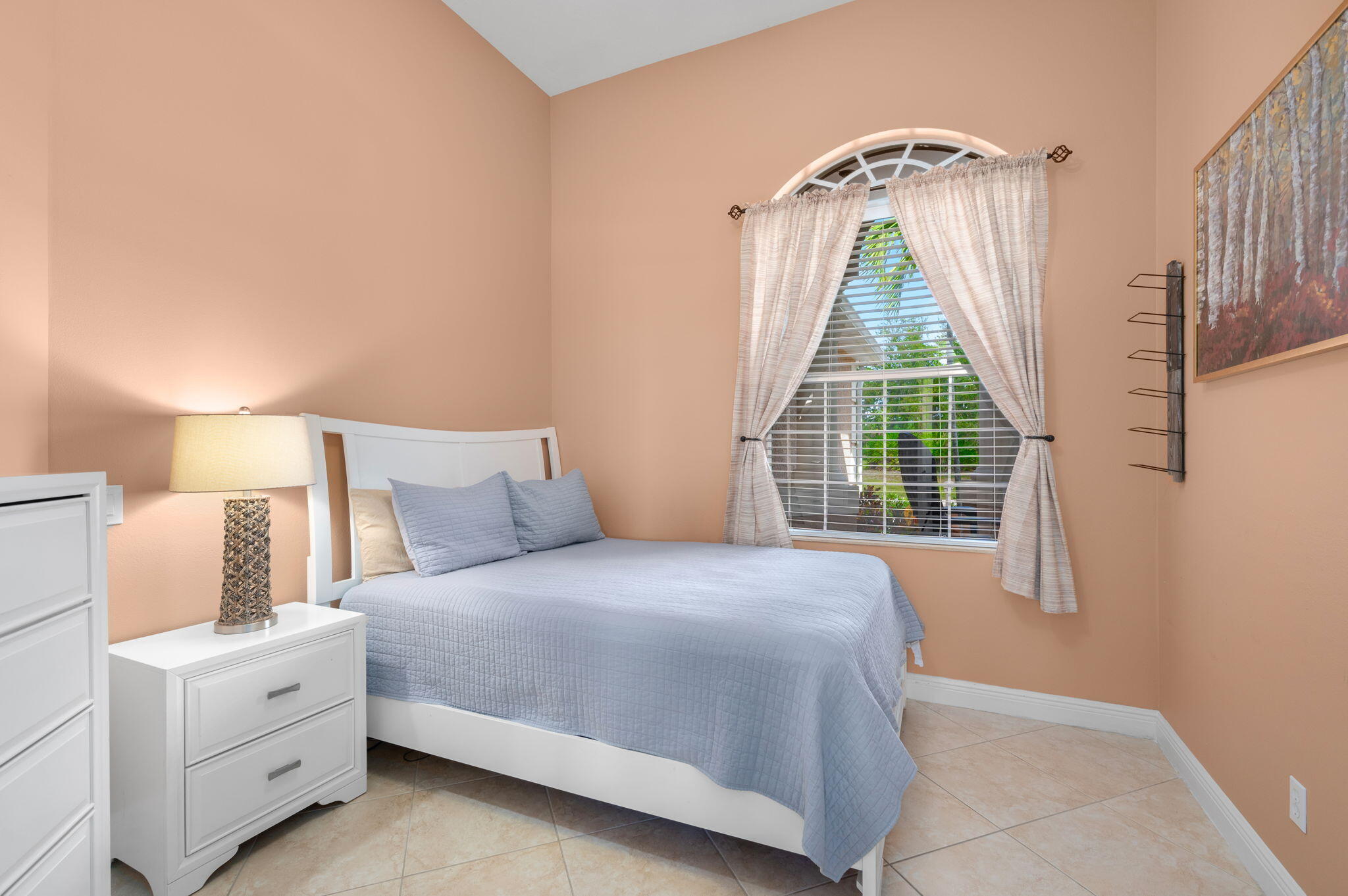1438 Southwest Apache Avenue Port St. Lucie, FL 34953 - Photo 14 of 34 a bedroom with a bed and a window