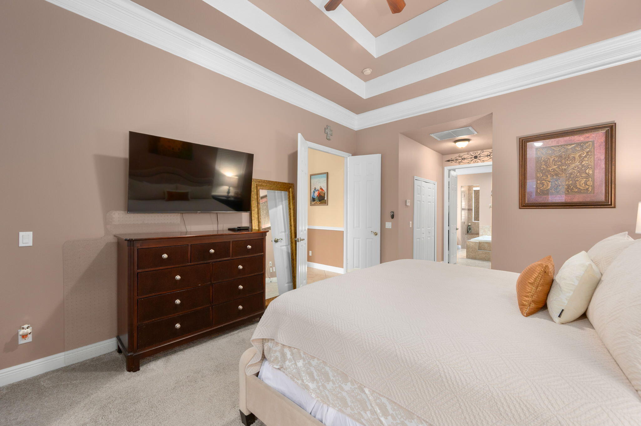 1438 Southwest Apache Avenue Port St. Lucie, FL 34953 - Photo 19 of 34 a bedroom with a bed and a flat screen tv