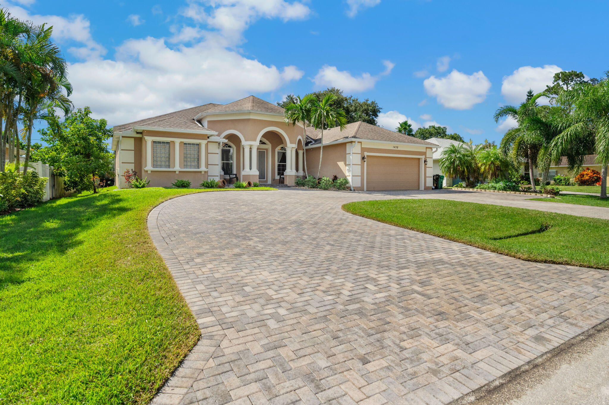 1438 Southwest Apache Avenue Port St. Lucie, FL 34953 - Photo 2 of 34 a front view of a house with garden