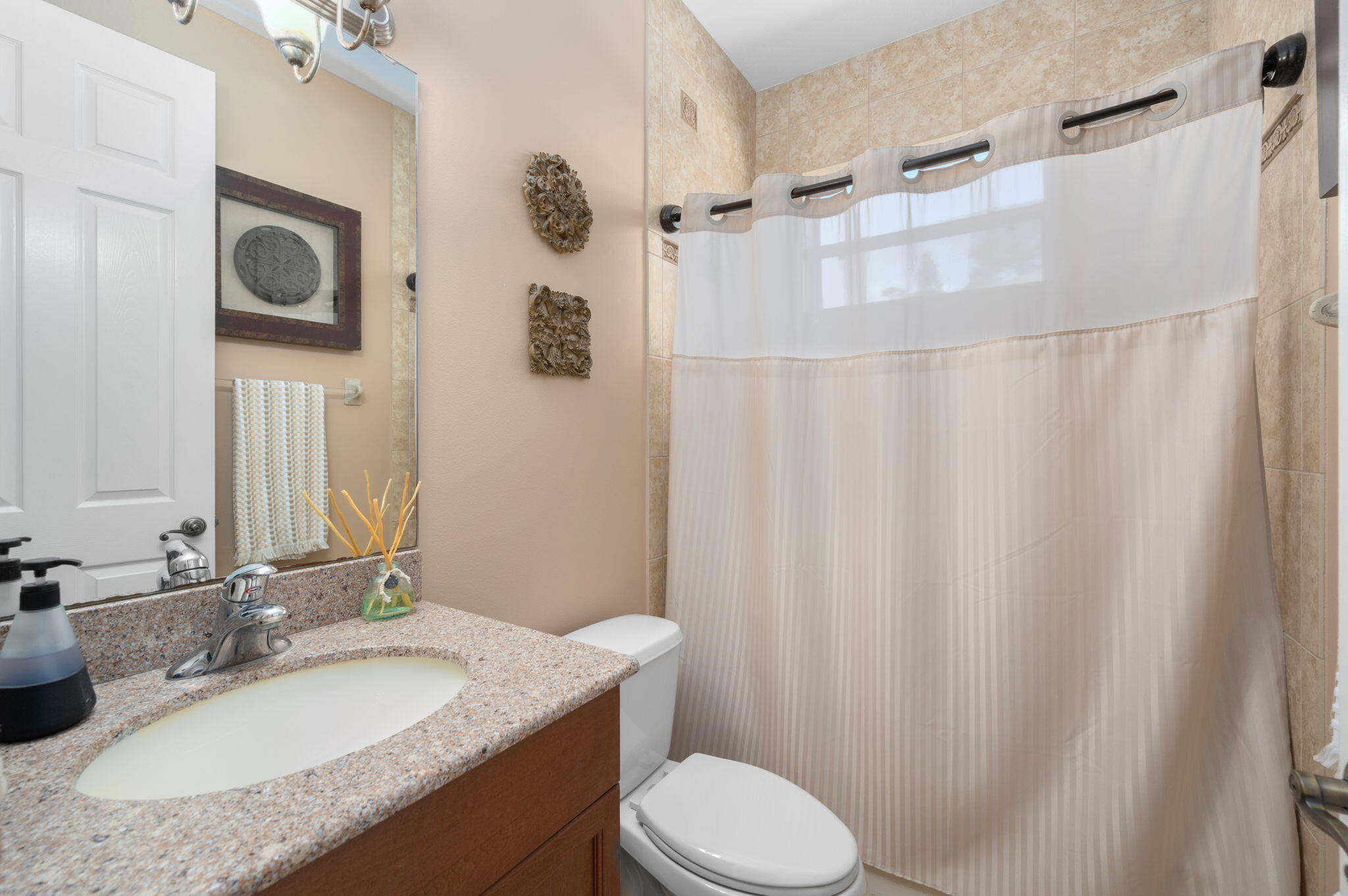 1438 Southwest Apache Avenue Port St. Lucie, FL 34953 - Photo 27 of 34 a bathroom with a granite countertop sink toilet and shower