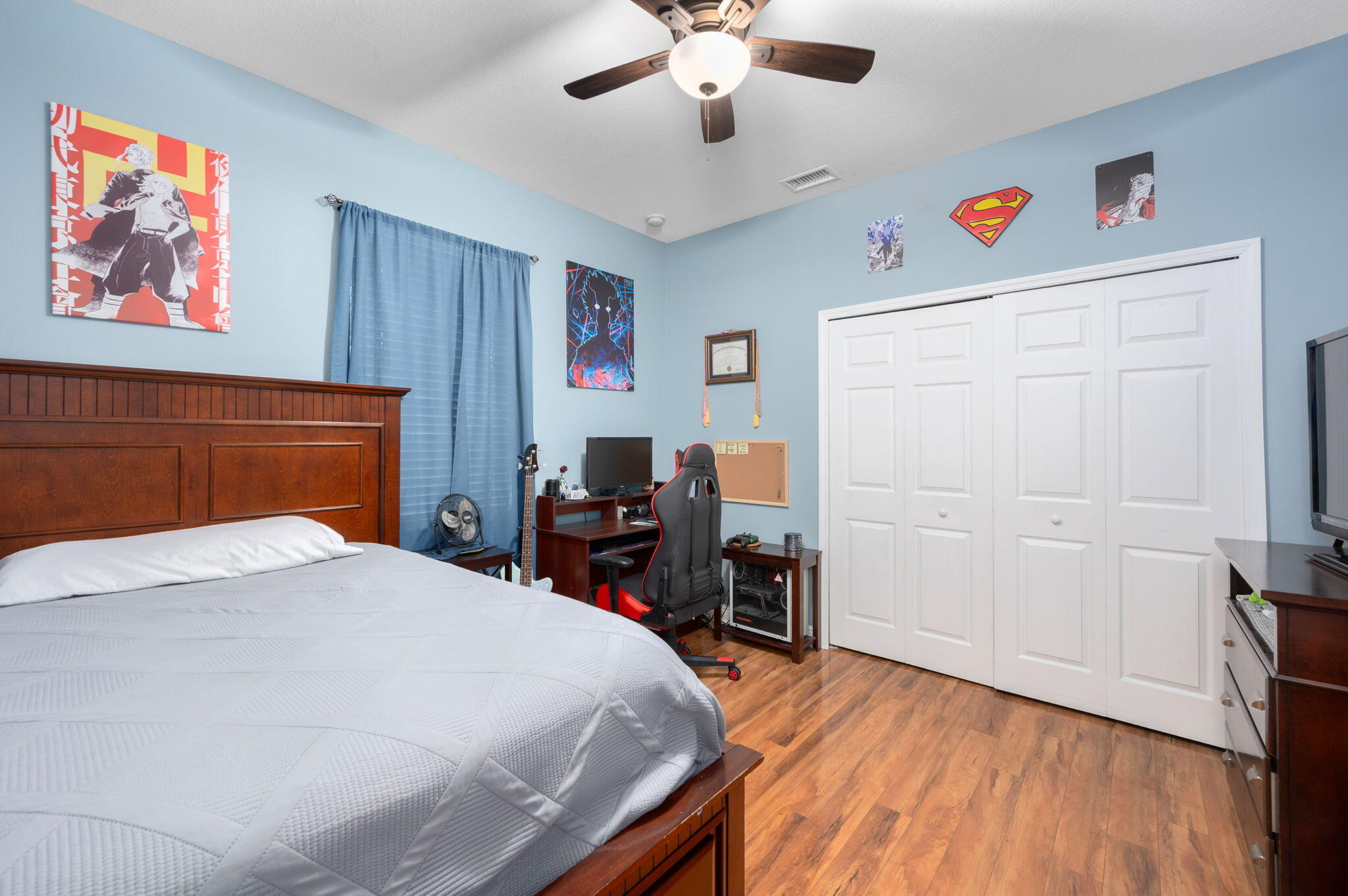 1438 Southwest Apache Avenue Port St. Lucie, FL 34953 - Photo 28 of 34 a bedroom with a bed and a book shelf