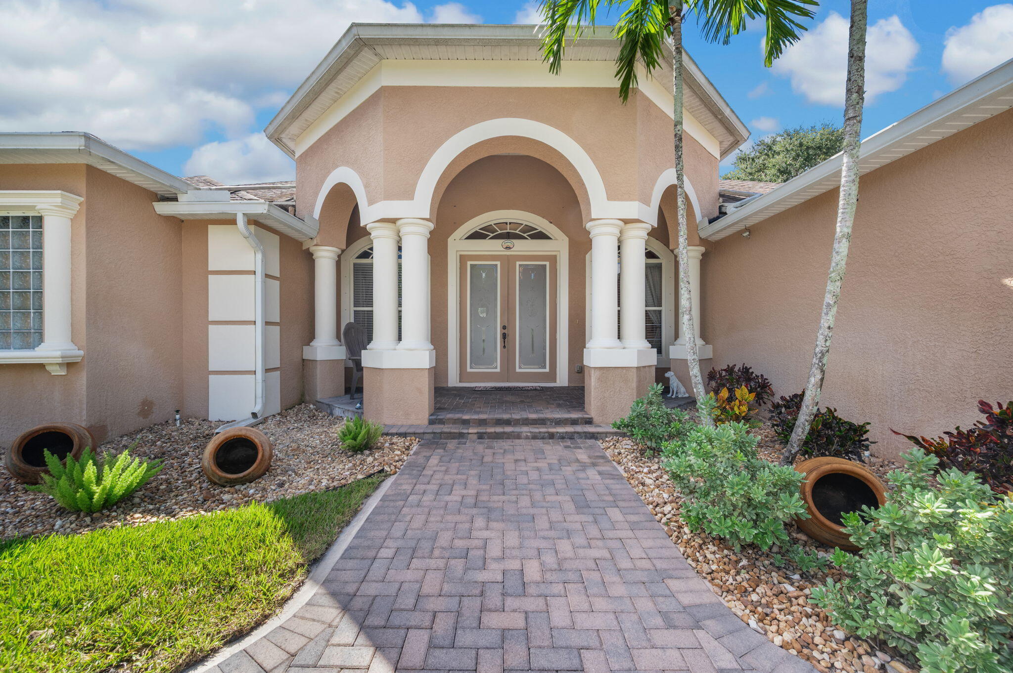 1438 Southwest Apache Avenue Port St. Lucie, FL 34953 - Photo 3 of 34 a front view of a house with garden