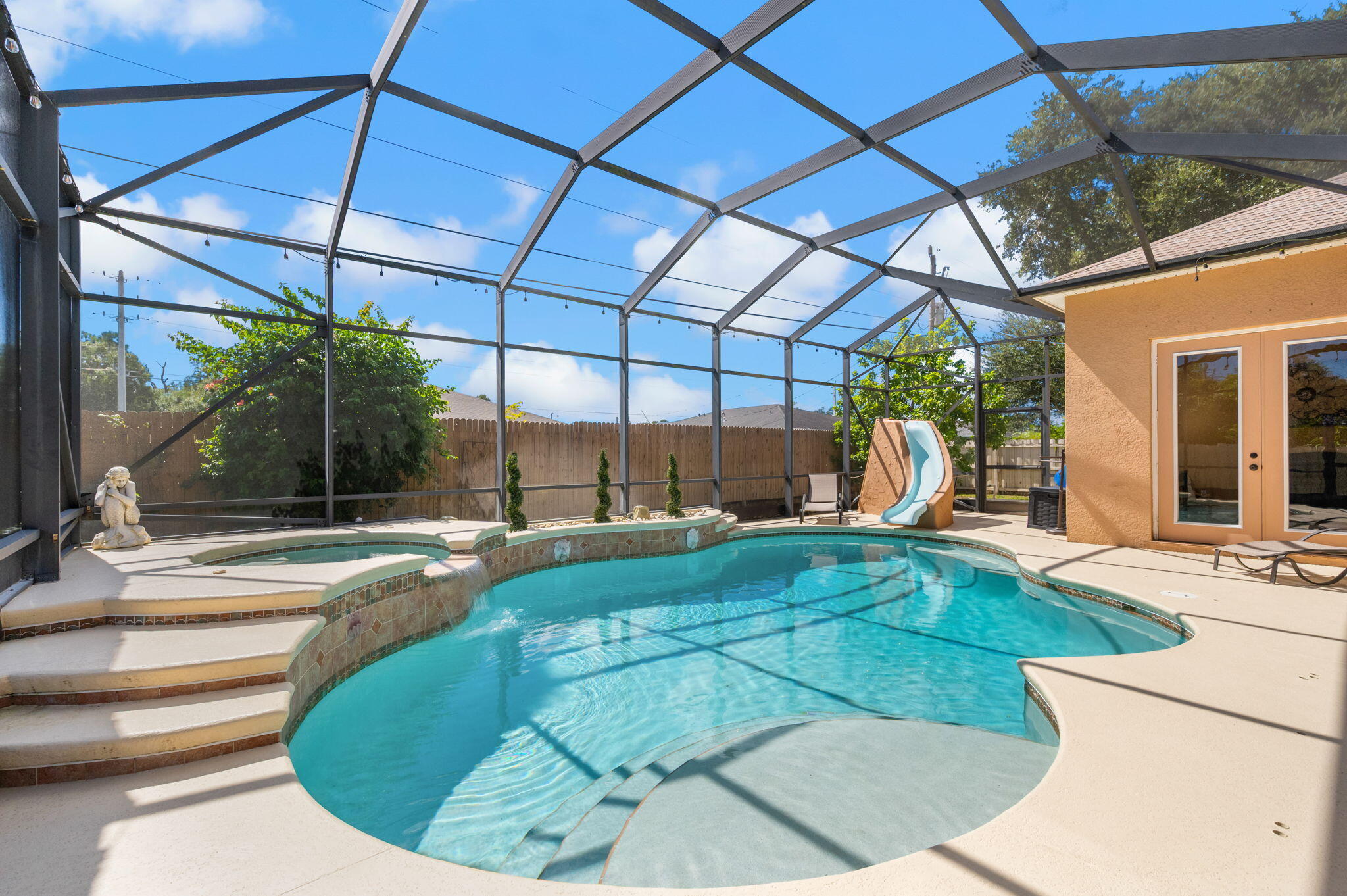 1438 Southwest Apache Avenue Port St. Lucie, FL 34953 - Photo 32 of 34 a view of a swimming pool with a patio