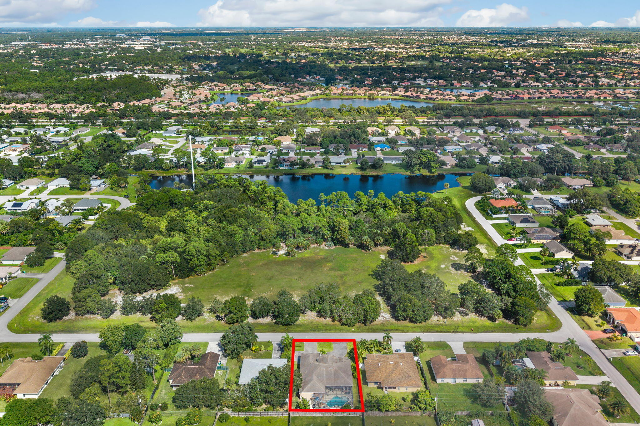 1438 Southwest Apache Avenue Port St. Lucie, FL 34953 - Photo 34 of 34 an aerial view of residential houses with outdoor space and trees