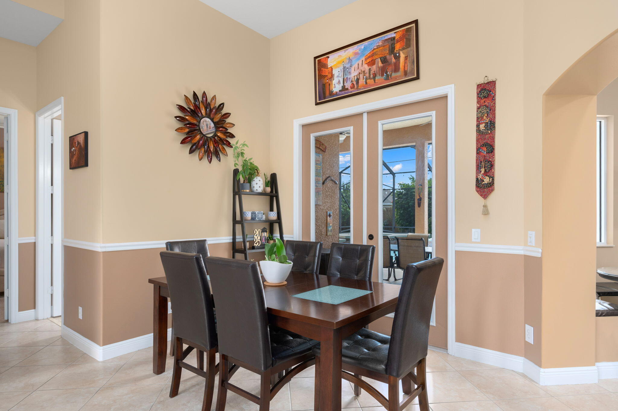 1438 Southwest Apache Avenue Port St. Lucie, FL 34953 - Photo 5 of 34 a view of a dining room with furniture and a potted plant