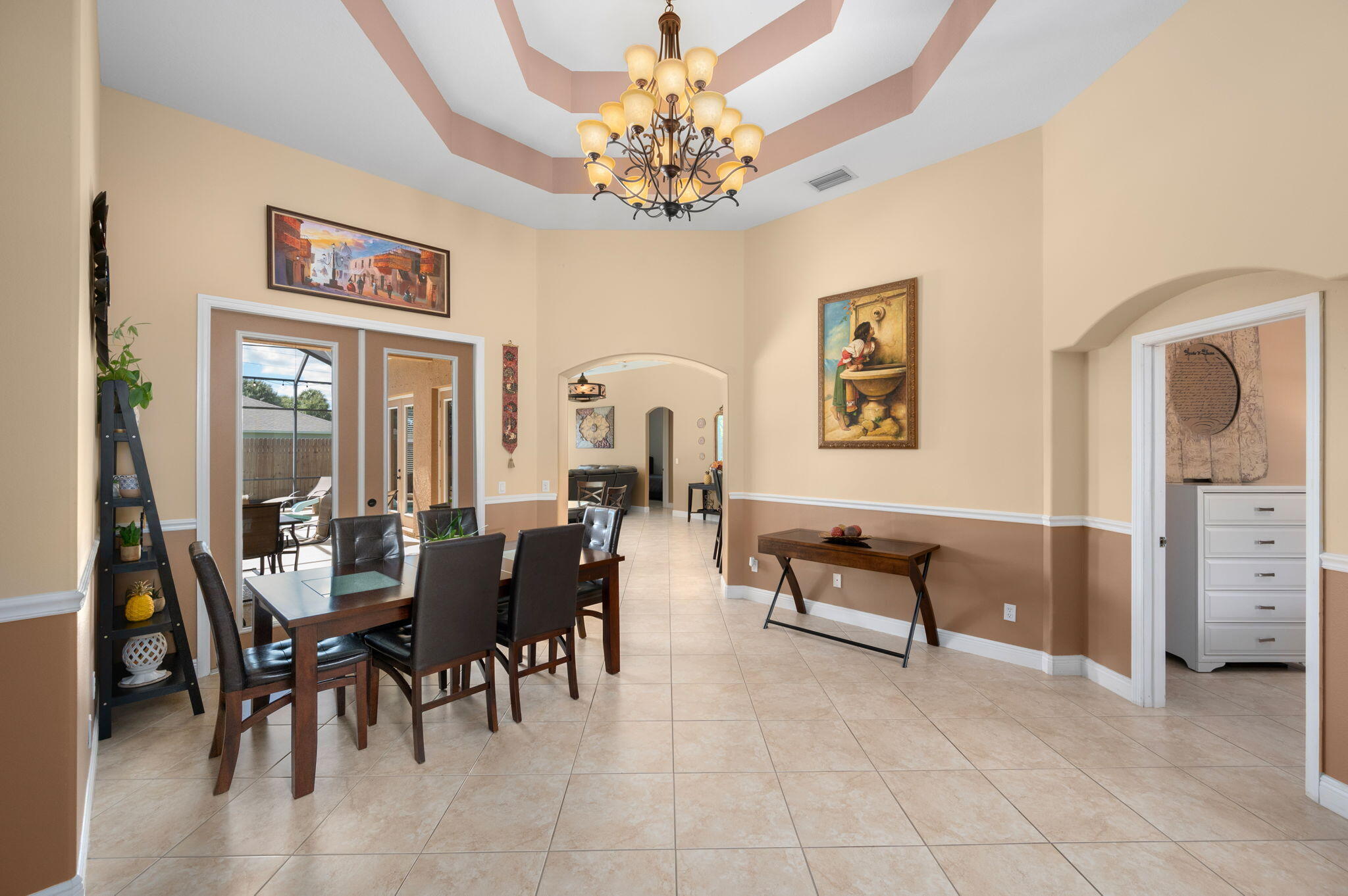 1438 Southwest Apache Avenue Port St. Lucie, FL 34953 - Photo 6 of 34 a view of a dining room with furniture and chandelier