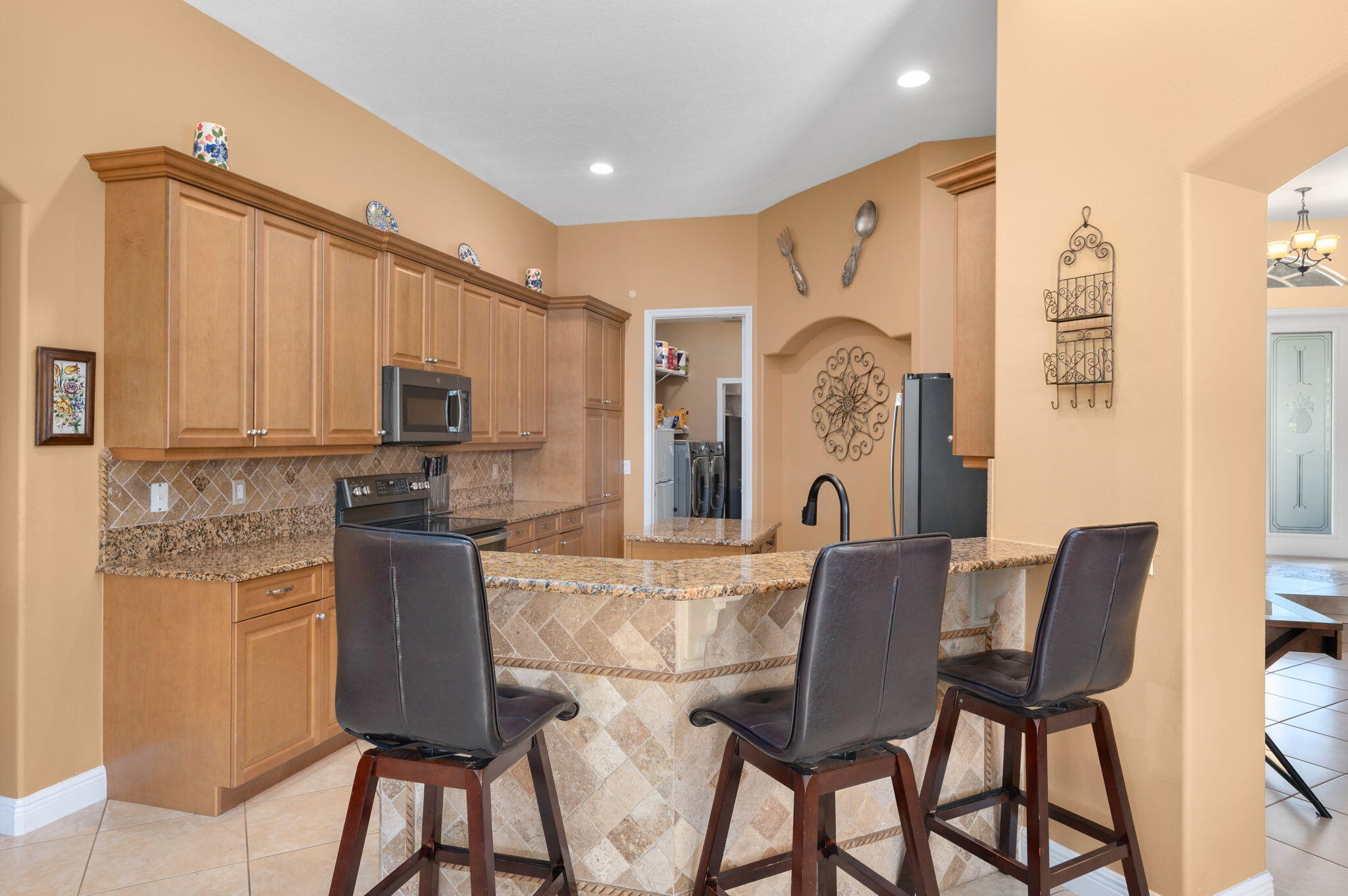 1438 Southwest Apache Avenue Port St. Lucie, FL 34953 - Photo 7 of 34 a view of a dining room with furniture and chandelier
