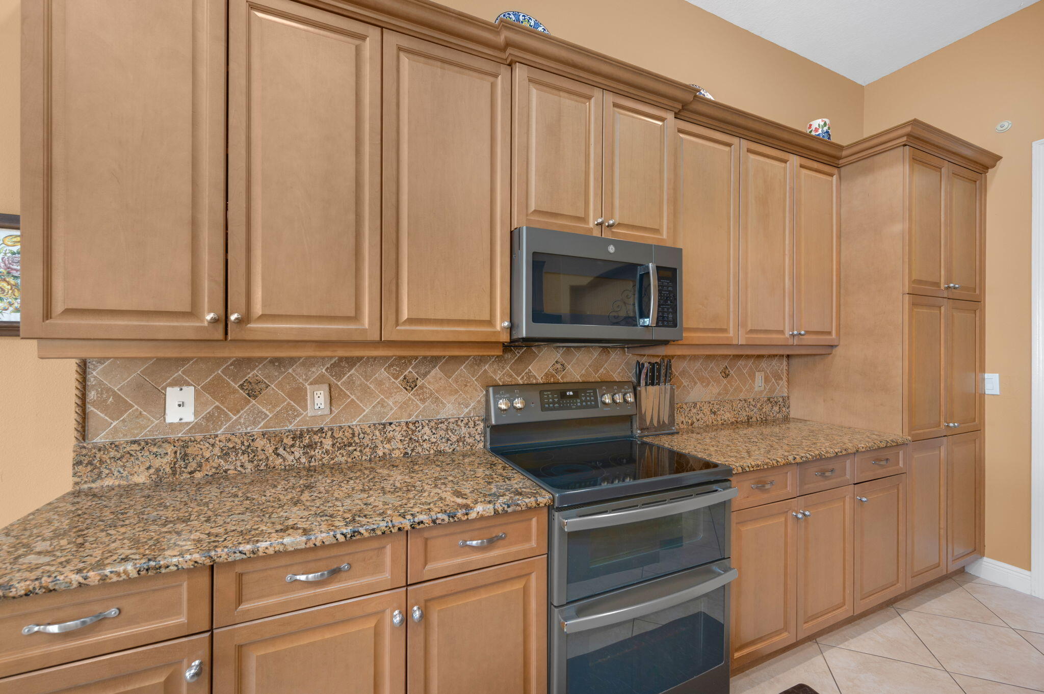 1438 Southwest Apache Avenue Port St. Lucie, FL 34953 - Photo 8 of 34 a kitchen with appliances cabinets and a counter top space