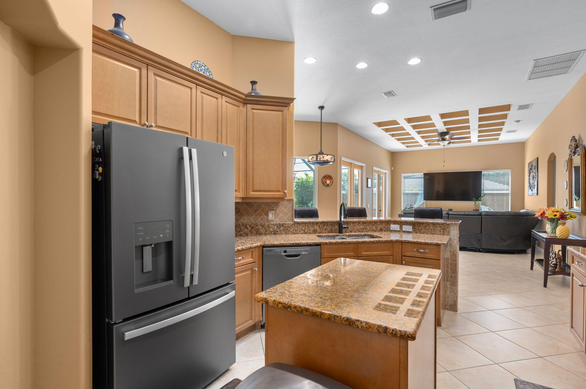 1438 Southwest Apache Avenue Port St. Lucie, FL 34953 - Photo 10 of 34 a kitchen with stainless steel appliances granite countertop a refrigerator stove microwave and sink