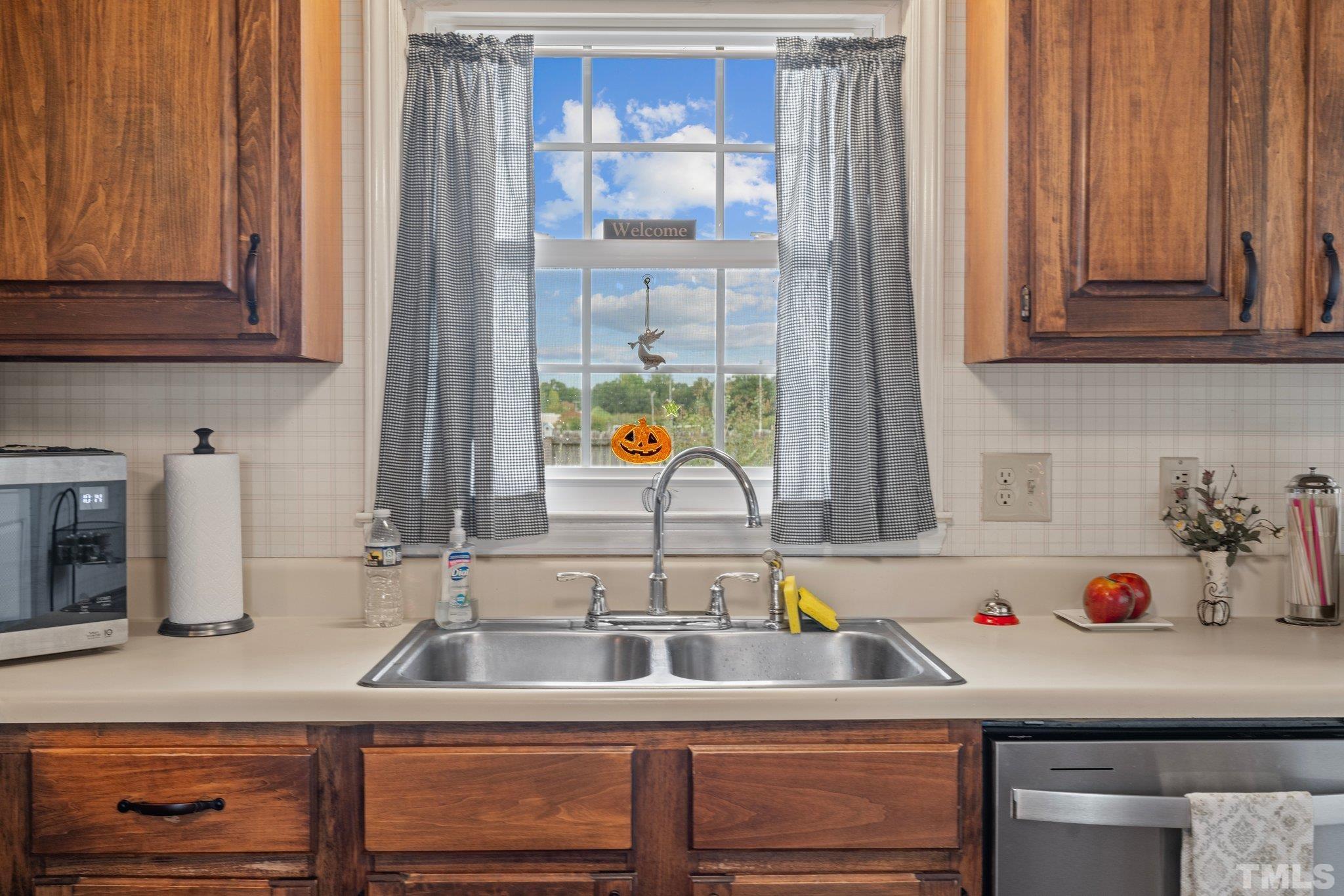 107 Murchison Drive Dunn, NC 28334 - Photo 11 of 37 a kitchen with a sink and a stove next to a window