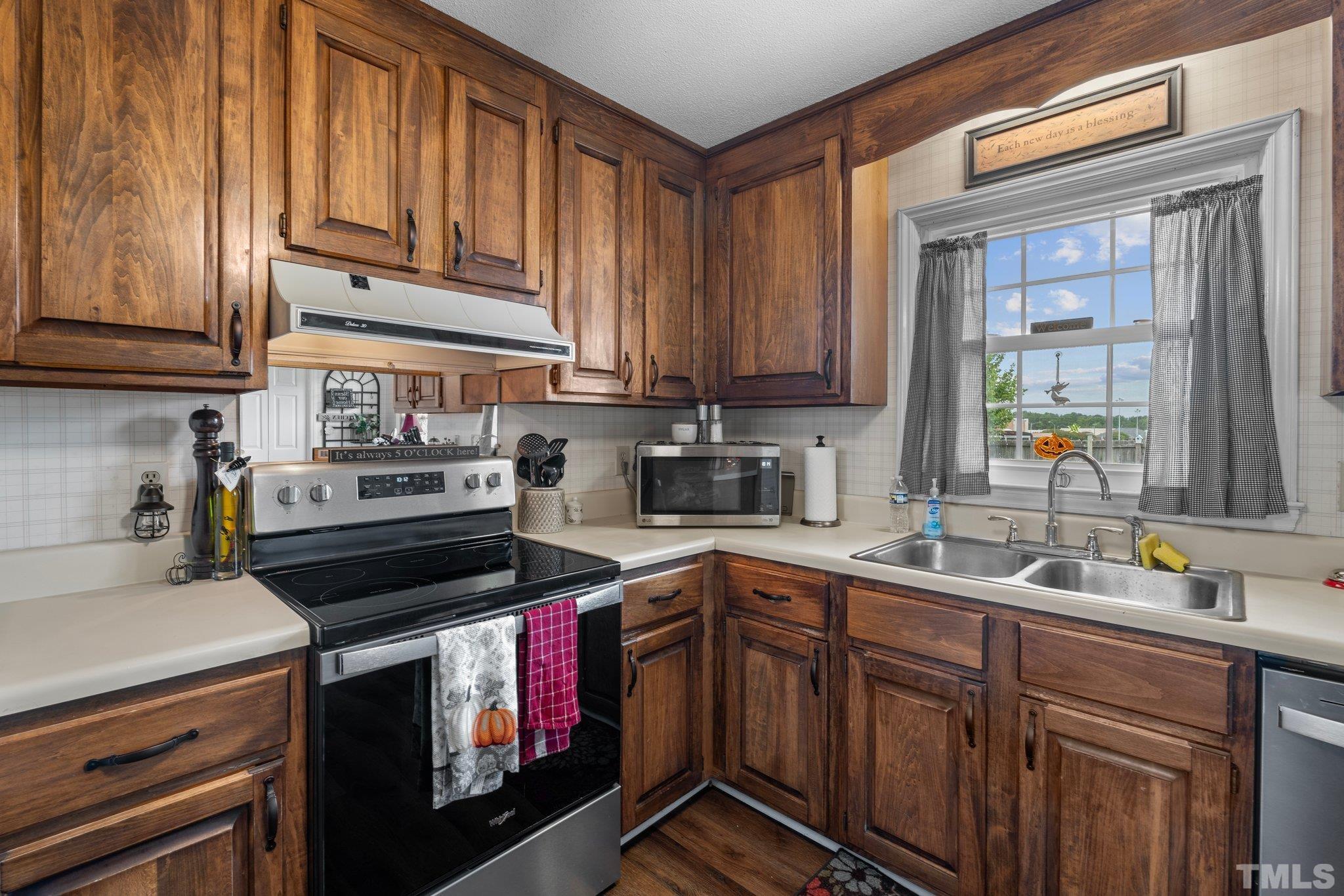 107 Murchison Drive Dunn, NC 28334 - Photo 12 of 37 a kitchen with a sink stove and cabinets