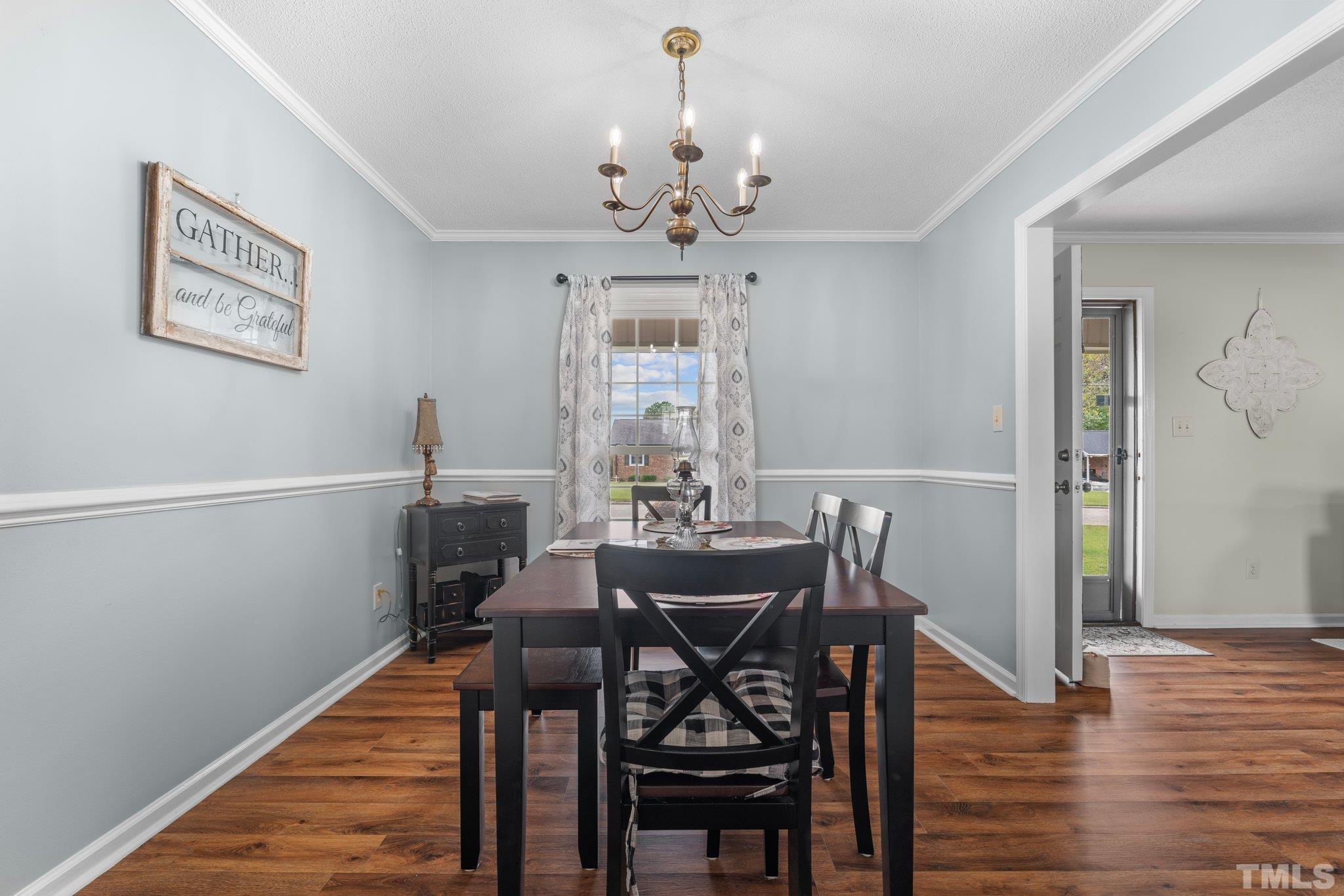 107 Murchison Drive Dunn, NC 28334 - Photo 16 of 37 a view of a dining room with furniture window and wooden floor