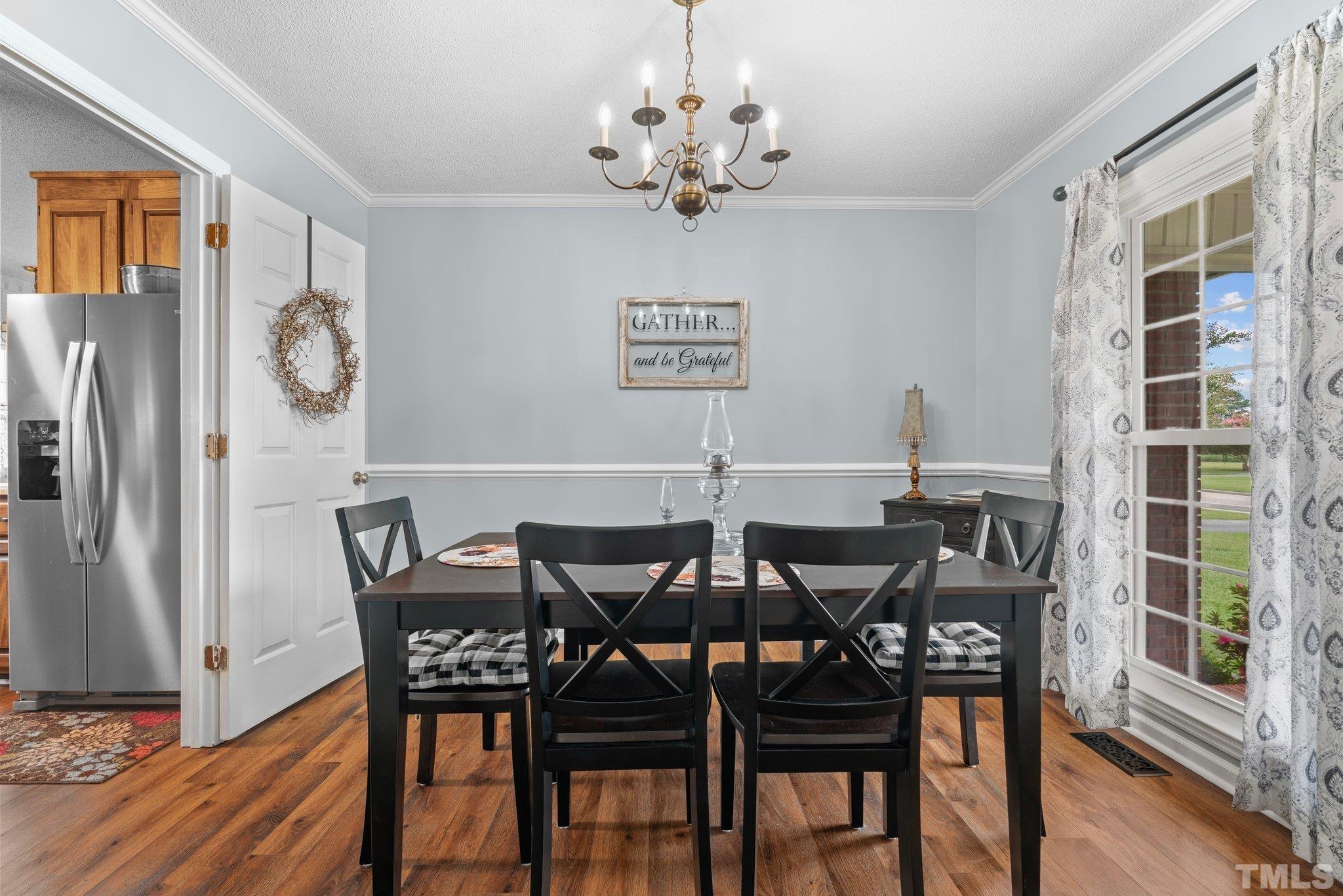 107 Murchison Drive Dunn, NC 28334 - Photo 17 of 37 a view of a dining room with furniture window and wooden floor