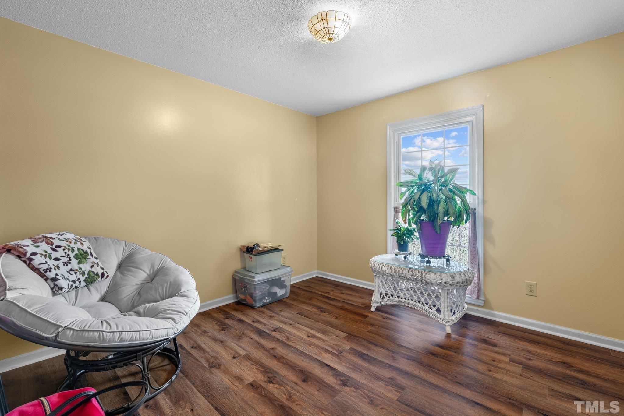 107 Murchison Drive Dunn, NC 28334 - Photo 20 of 37 a living room with furniture and a potted plant