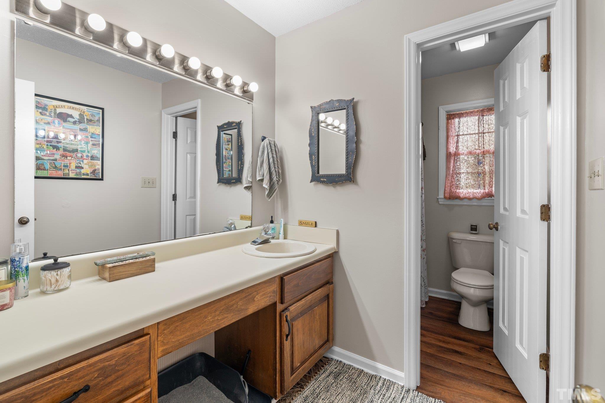 107 Murchison Drive Dunn, NC 28334 - Photo 22 of 37 a bathroom with a sink and a mirror