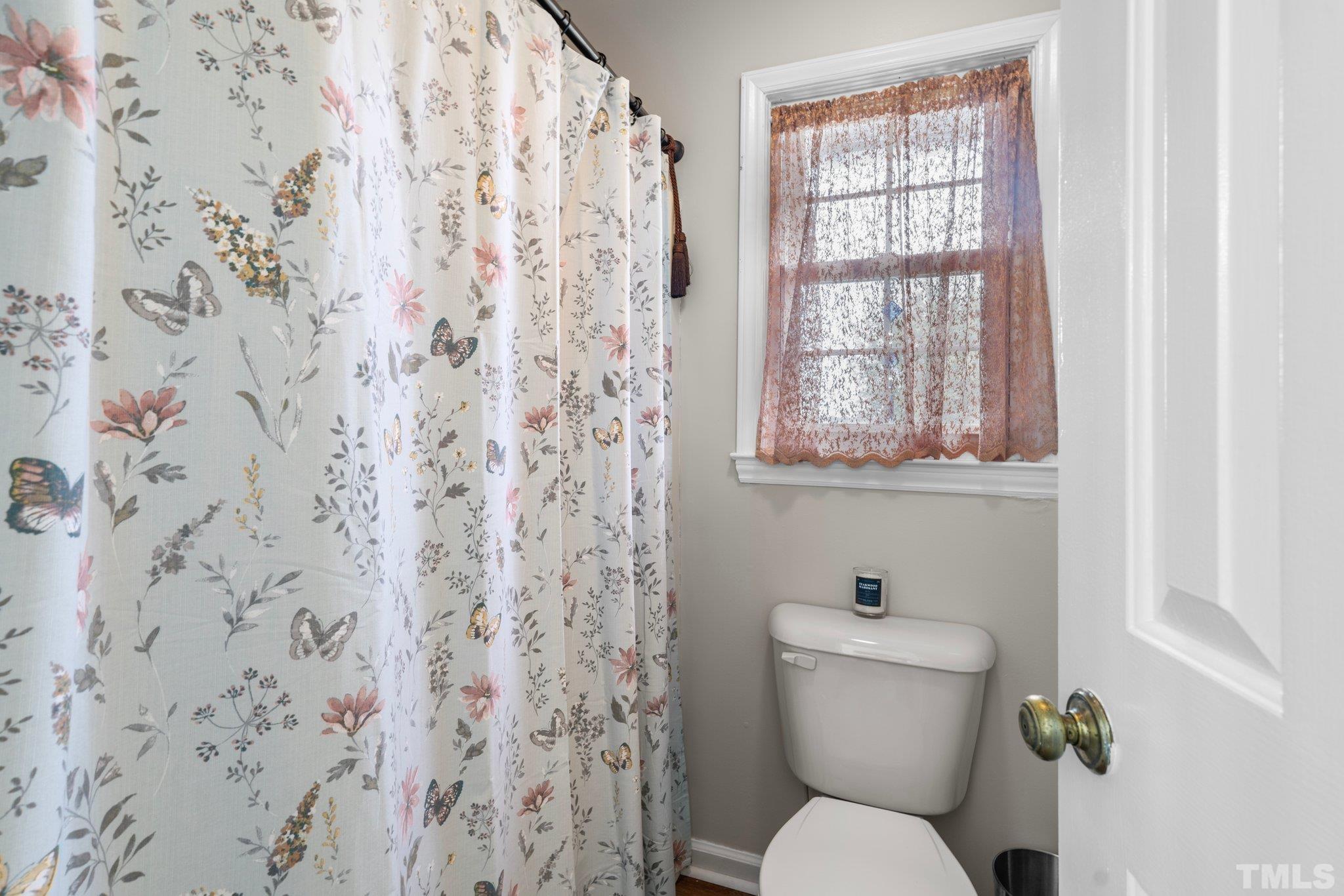 107 Murchison Drive Dunn, NC 28334 - Photo 23 of 37 a bathroom with a toilet and a window