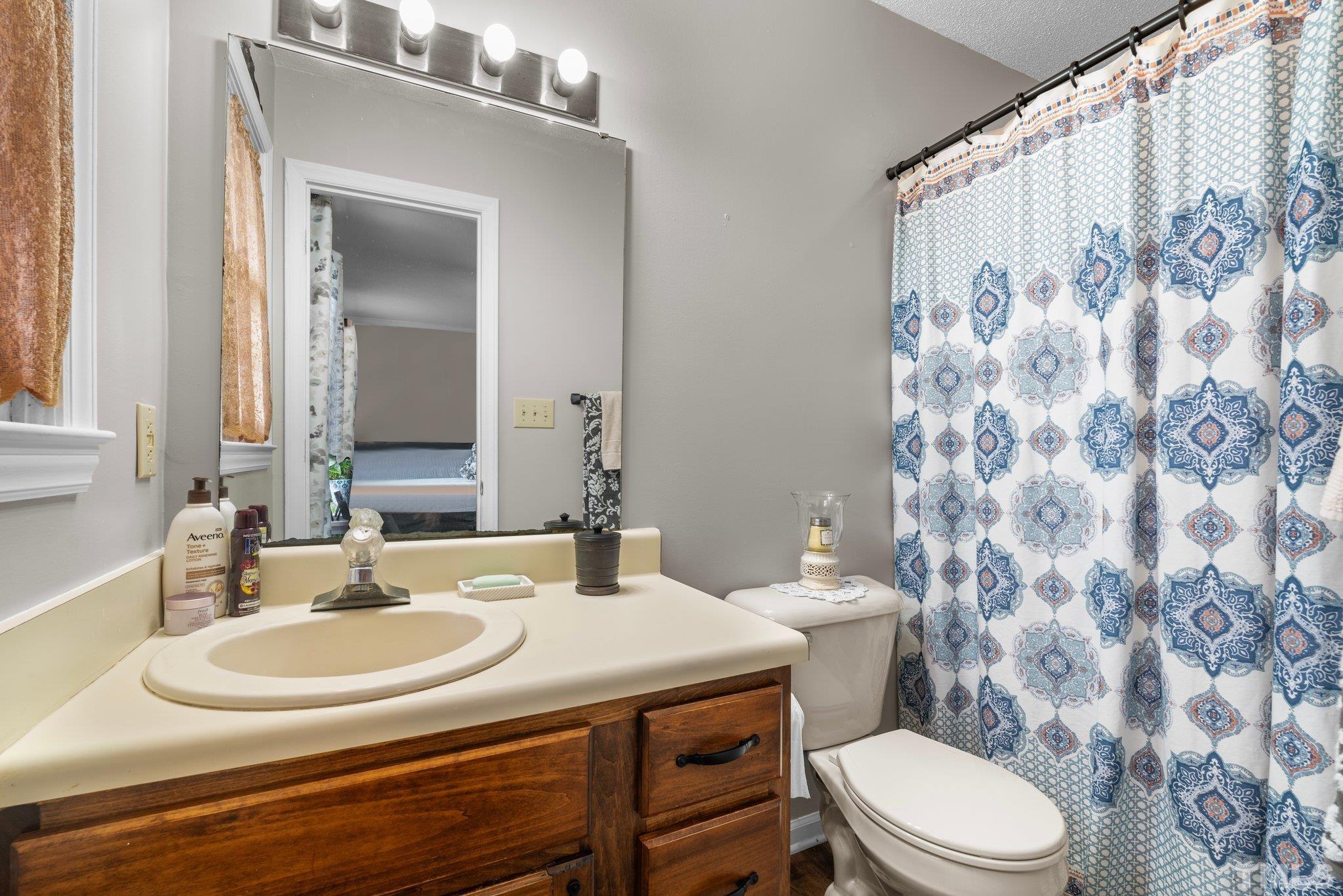107 Murchison Drive Dunn, NC 28334 - Photo 26 of 37 a bathroom with a sink and a mirror