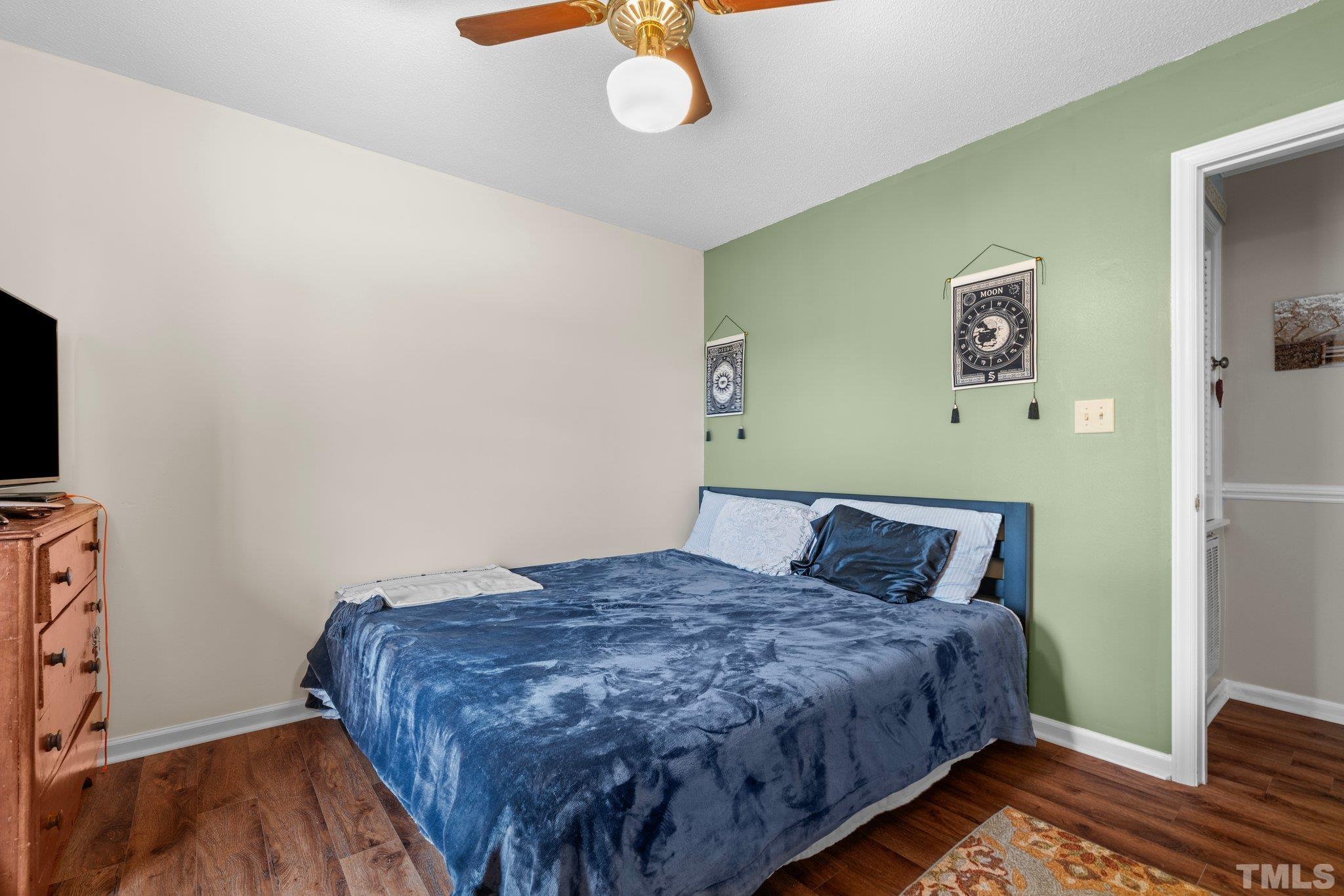 107 Murchison Drive Dunn, NC 28334 - Photo 28 of 37 a bedroom with a bed and a flat screen tv