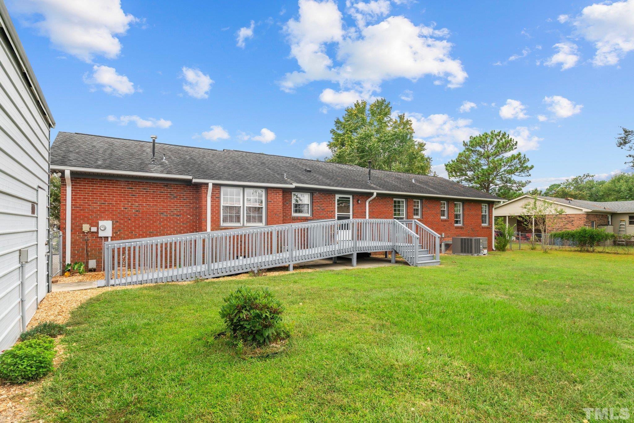 107 Murchison Drive Dunn, NC 28334 - Photo 29 of 37 a backyard of a house with table and chairs