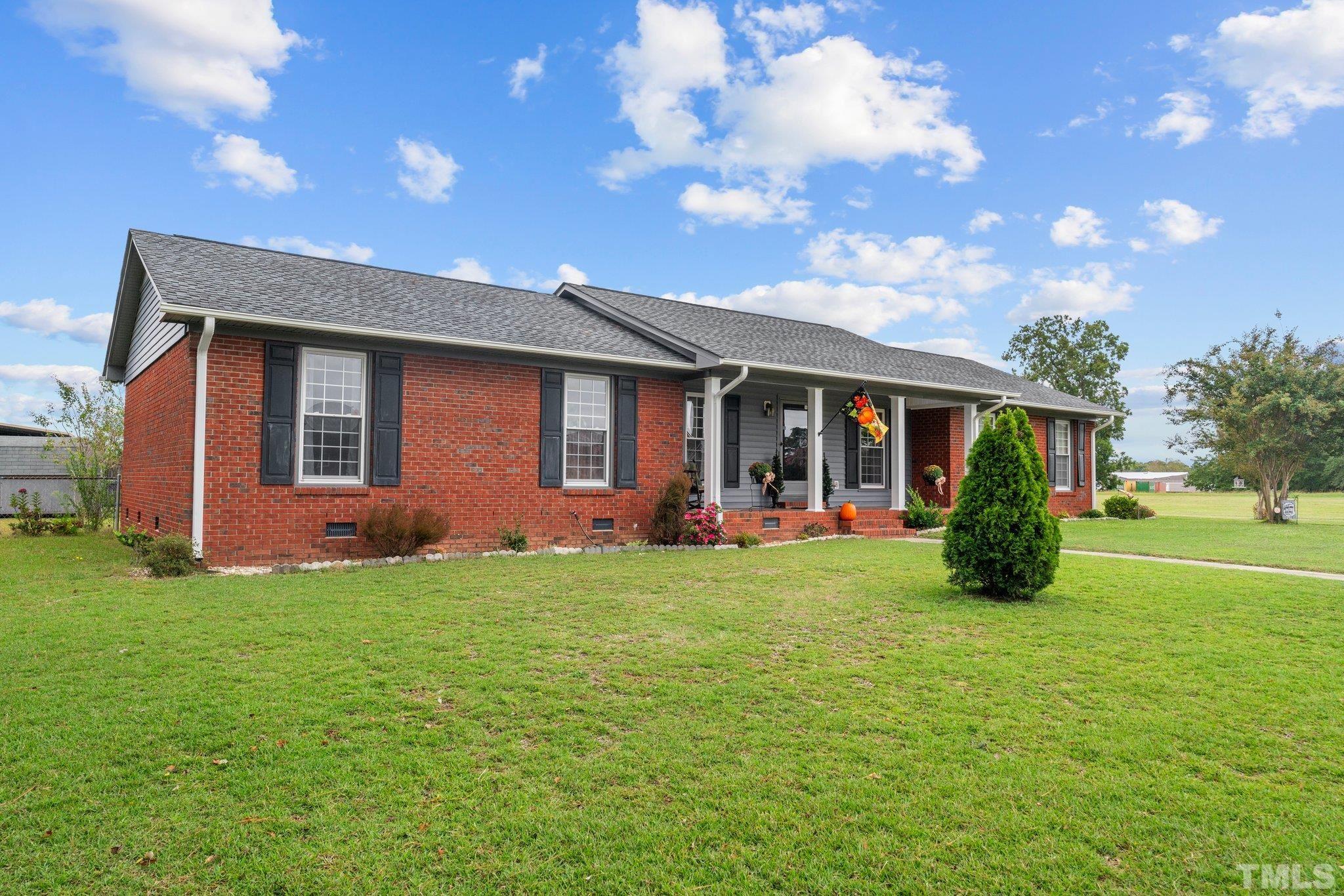 107 Murchison Drive Dunn, NC 28334 - Photo 3 of 37 a view of a house with backyard porch and garden