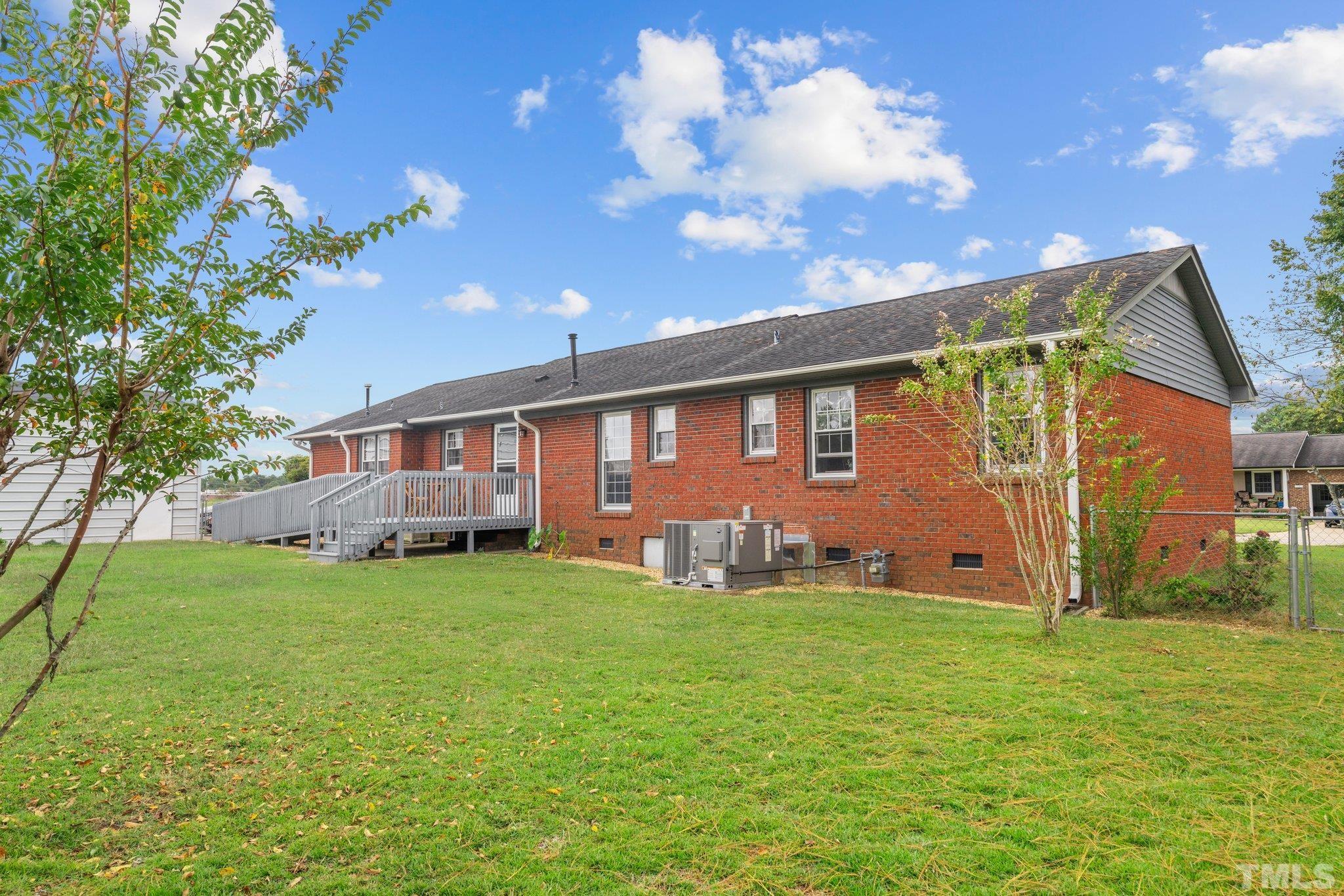 107 Murchison Drive Dunn, NC 28334 - Photo 32 of 37 a front view of a house with garden