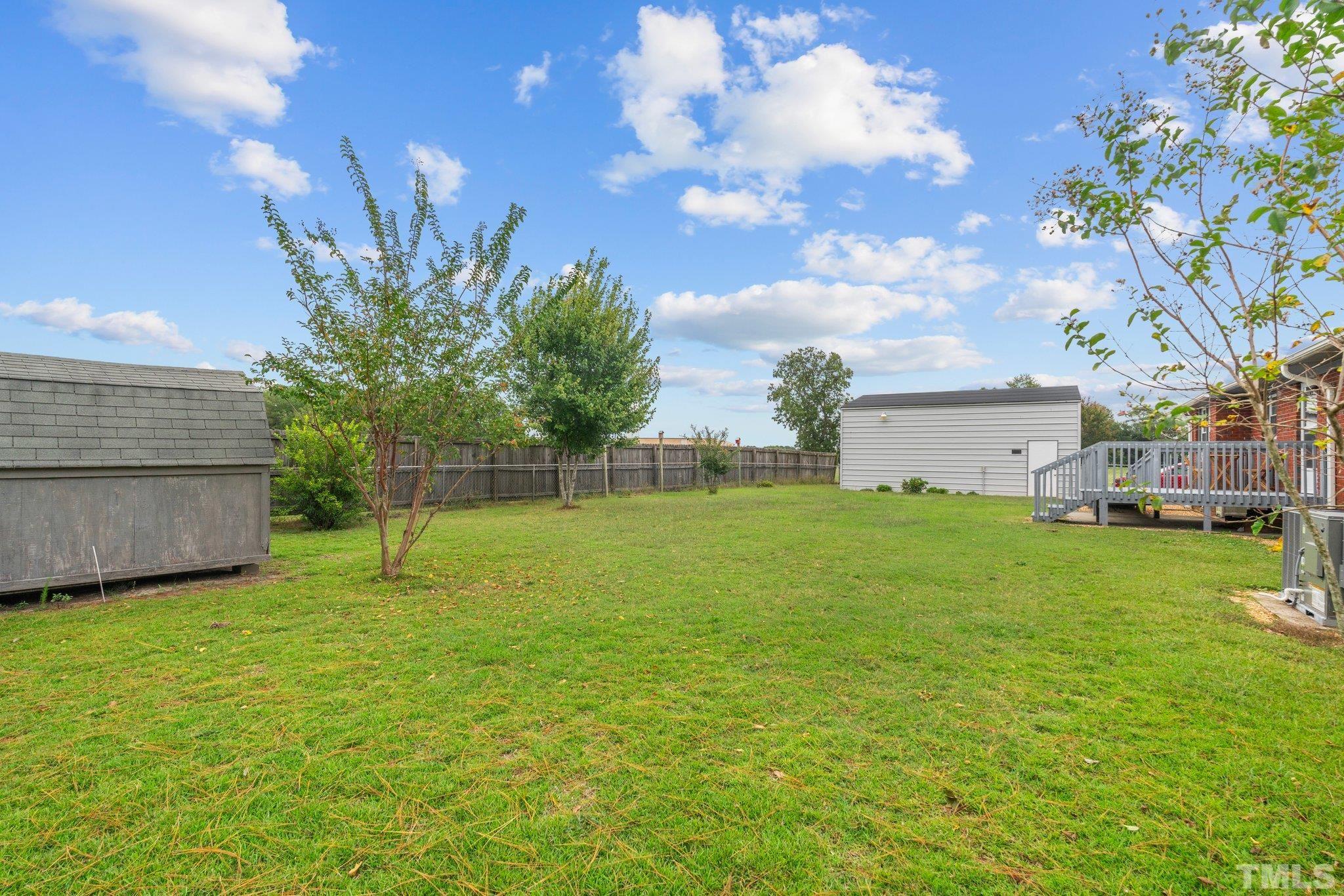 107 Murchison Drive Dunn, NC 28334 - Photo 33 of 37 a view of a house with a backyard