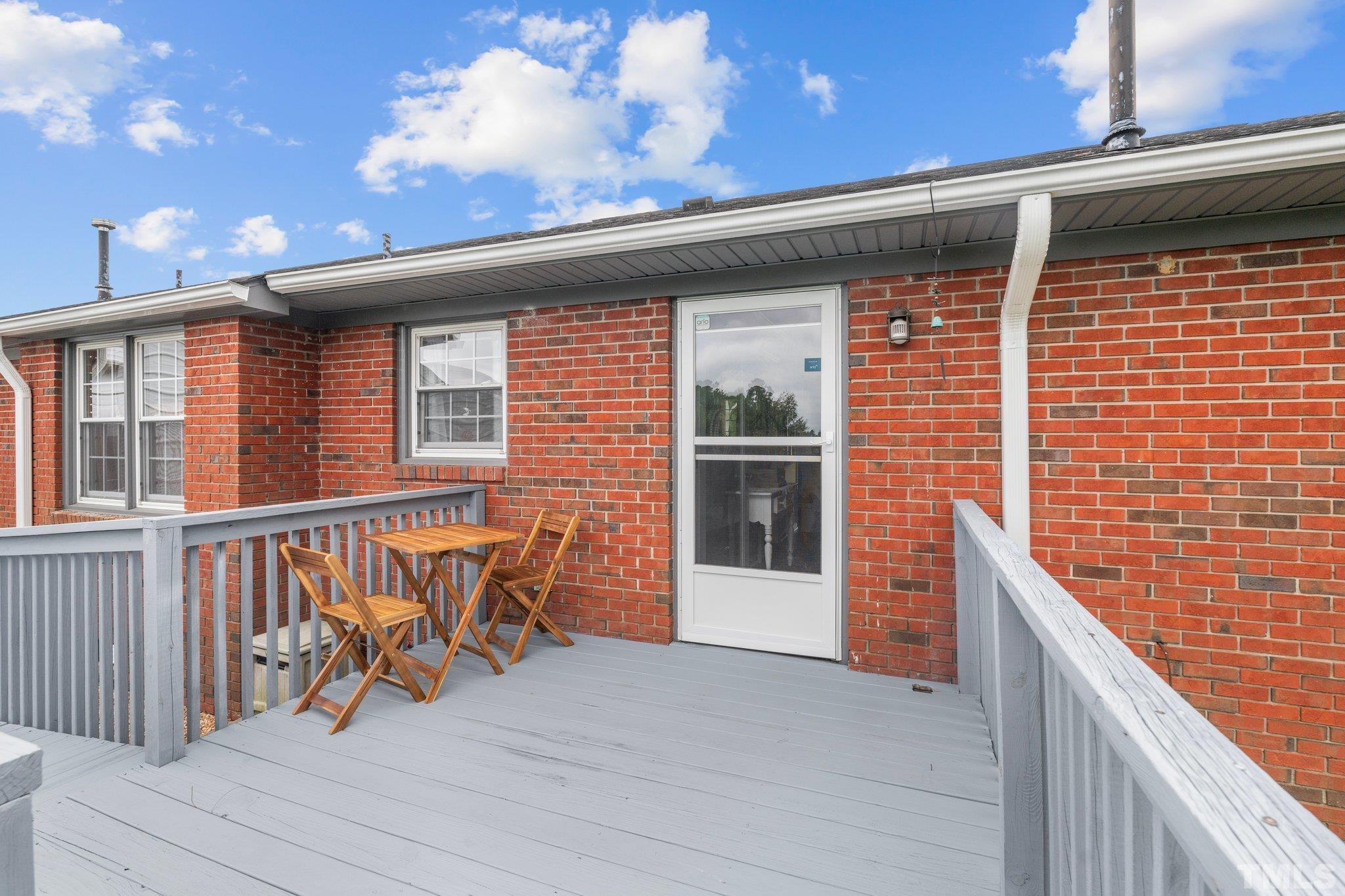 107 Murchison Drive Dunn, NC 28334 - Photo 34 of 37 a view of a balcony with chairs and wooden fence