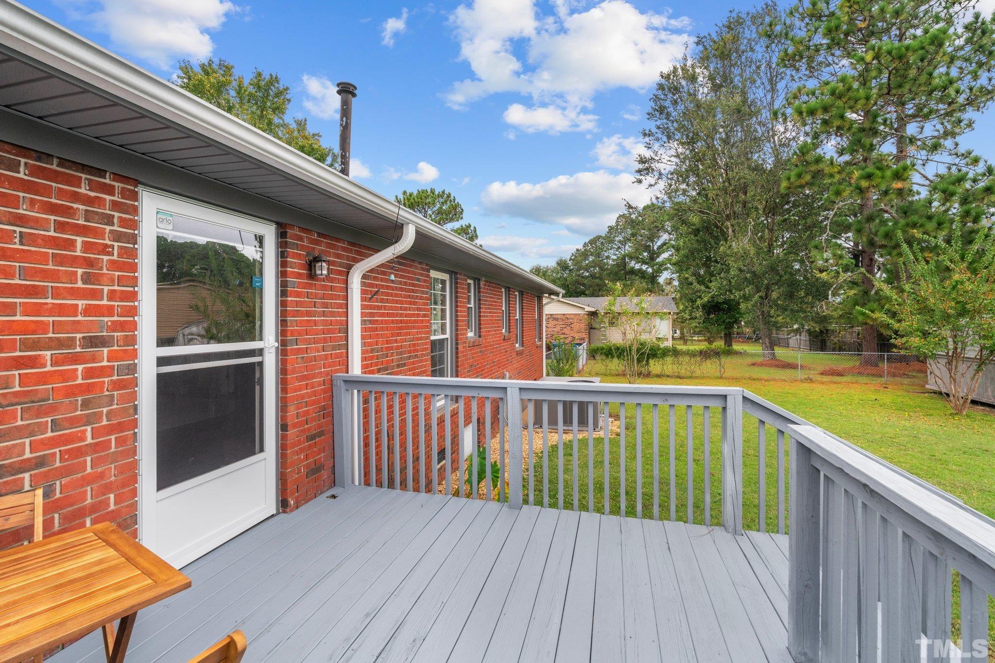 107 Murchison Drive Dunn, NC 28334 - Photo 35 of 37 a view of a balcony with wooden floor and outdoor space