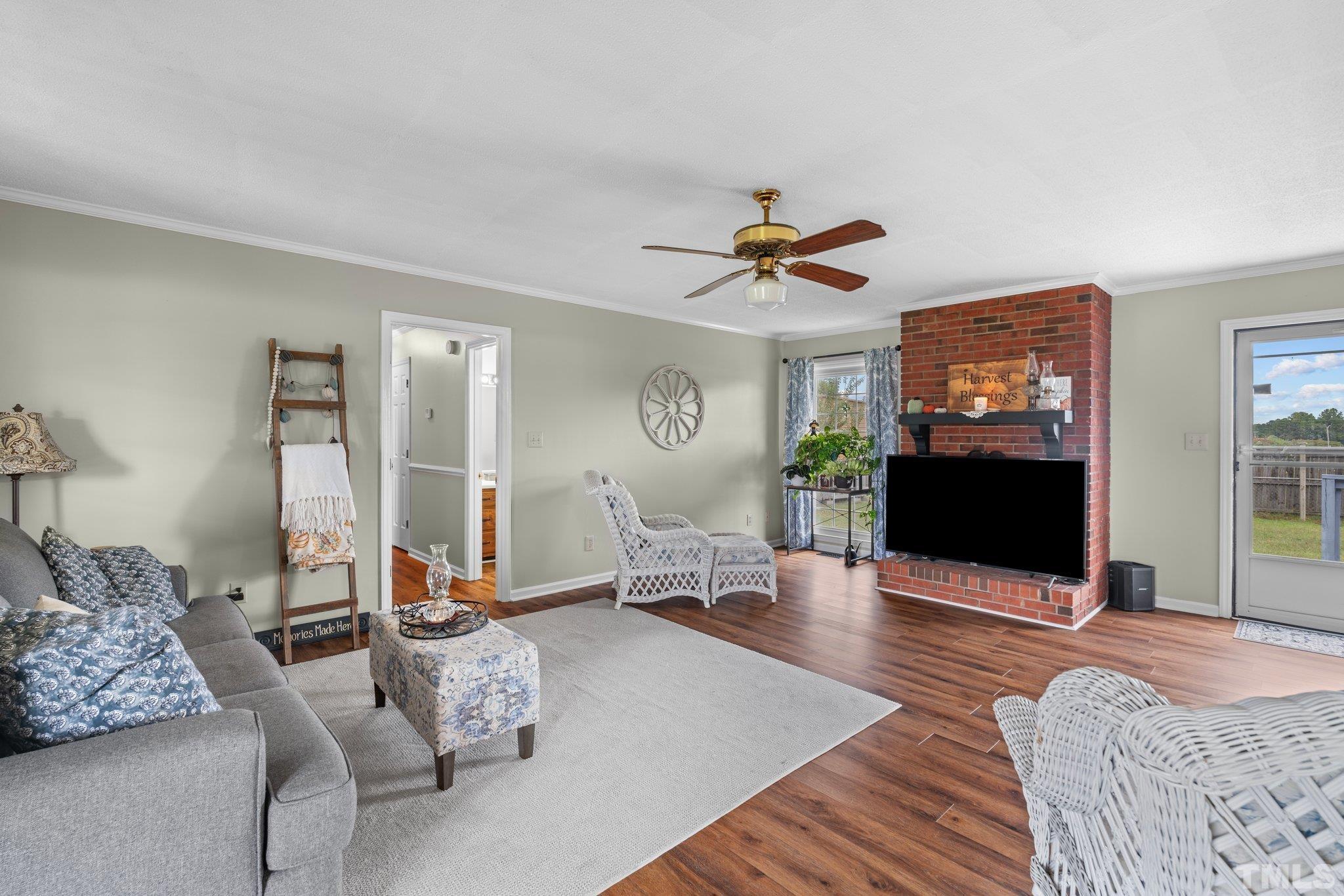 107 Murchison Drive Dunn, NC 28334 - Photo 4 of 37 a living room with furniture and a flat screen tv