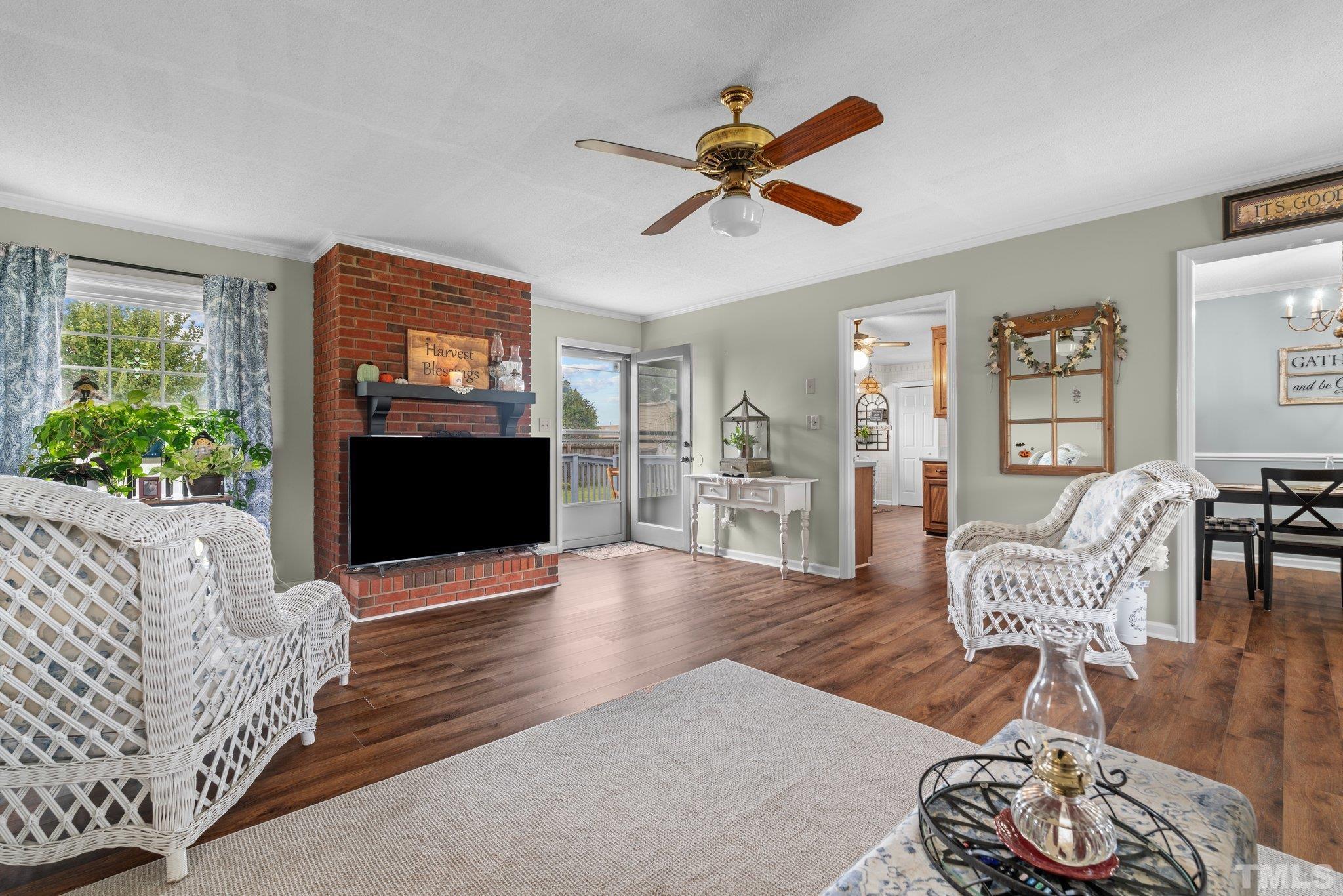 107 Murchison Drive Dunn, NC 28334 - Photo 6 of 37 a living room with furniture and a fireplace